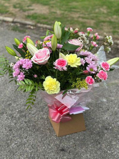 Sweet Blush - A soft and cheerful bouquet designed with a delicate blend of pastel pinks, gentle yellows, and fresh greenery. Light, airy textures and charming accents create a natural meadow-inspired feel, while the elegant wrap and coordinating bow add a polished finish. This arrangement offers a lovely balance of sweetness and freshness, making it perfect for birthdays, thoughtful gifts, or simply brightening someone’s day.