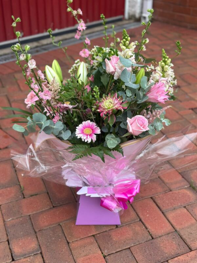 Pink Whisper - A graceful and romantic bouquet featuring soft shades of blush pink, creamy whites, and fresh greenery. Designed with a natural, airy style, this arrangement showcases height, texture, and gentle movement, creating a fresh-from-the-garden feel. Wrapped beautifully with a coordinating presentation and finished with a delicate bow, it’s perfect for special occasions, heartfelt gifts, or adding a touch of timeless charm to any space.