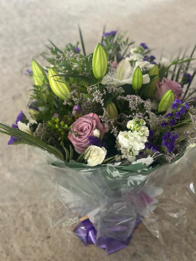 Twilight Garden Bouquet - A refined and graceful bouquet featuring a soothing palette of soft lavender tones, crisp whites, and fresh greenery. Designed with elegant height and gentle movement, this arrangement blends delicate textures with rich accents to create a calm, sophisticated feel. Beautifully wrapped and finished with a coordinating ribbon, it’s perfect for thoughtful gifts, special occasions, or bringing a touch of serene beauty to any space.