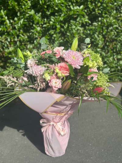 Grace - A soft and romantic arrangement featuring delicate blush tones, gentle greens, and subtle textures arranged in a loose, natural style. The design captures a fresh-from-the-garden feel with graceful movement and layered depth. Wrapped in elegant pastel paper and finished with a coordinating ribbon, this arrangement is perfect for heartfelt gifts, celebrations, or adding a touch of understated beauty to any moment.