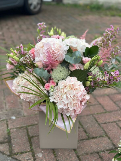 Blush Clouds - A soft and luxurious bouquet featuring layers of delicate blush tones, gentle pinks, and fresh green accents. Designed with a full, cloud-like shape, this arrangement offers a romantic and elegant feel with beautiful texture and depth. Subtle filler details and flowing greenery add movement, while the refined wrap completes the look. Perfect for weddings, special occasions, or sending a graceful and heartfelt gift.