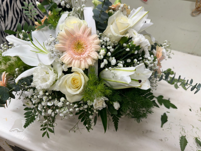 Blush of Memories - A soft and elegant funeral tribute arranged in gentle blush and ivory tones, thoughtfully designed to convey love, grace, and peaceful remembrance. Accented with delicate textures and fresh greenery, this arrangement offers a calm and comforting presence. Its refined, natural style symbolises purity, affection, and a tender goodbye, making it a beautiful expression of lasting love and cherished memories.